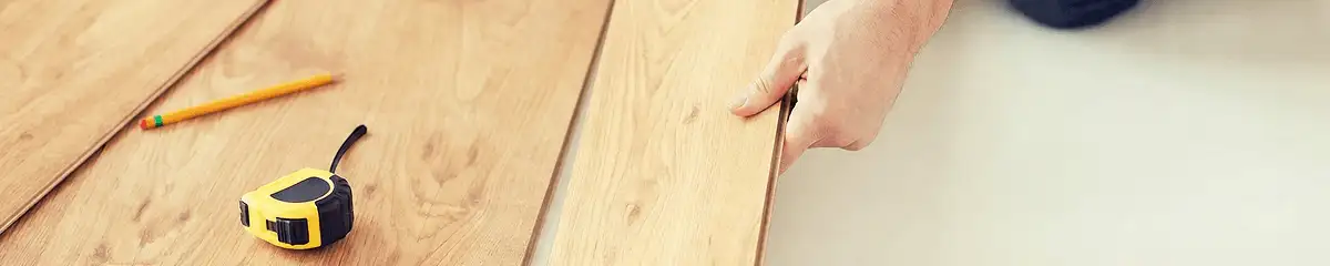 A professional installing wood flooring in Long Beach, CA
