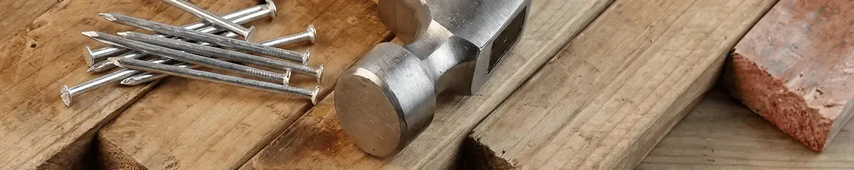 Hammer and nails on hardwood flooring boards in Long Beach, CA