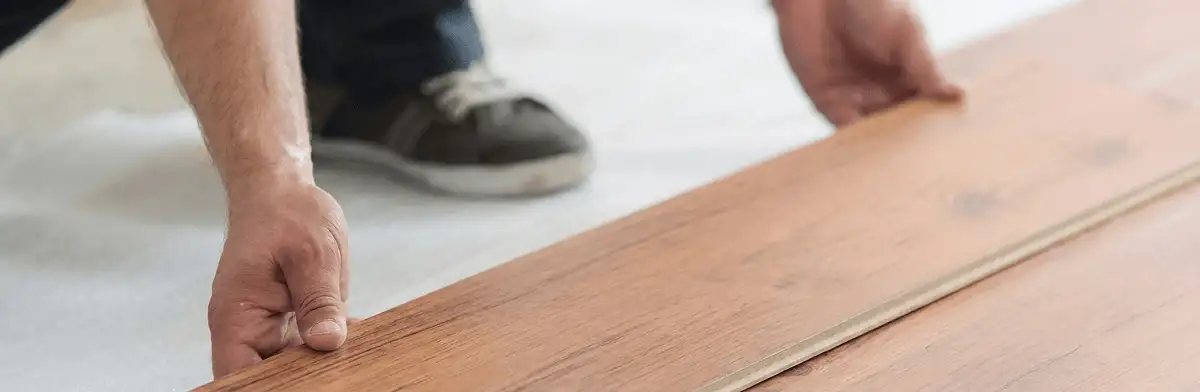 A professional installing laminate flooring in Long Beach, CA