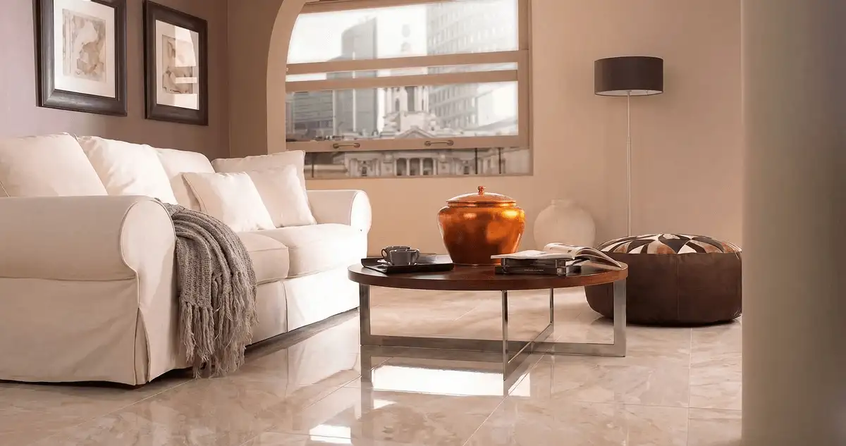 Modern living room with professionally installed marble flooring, a beige sofa, coffee table in Long Beach, CA